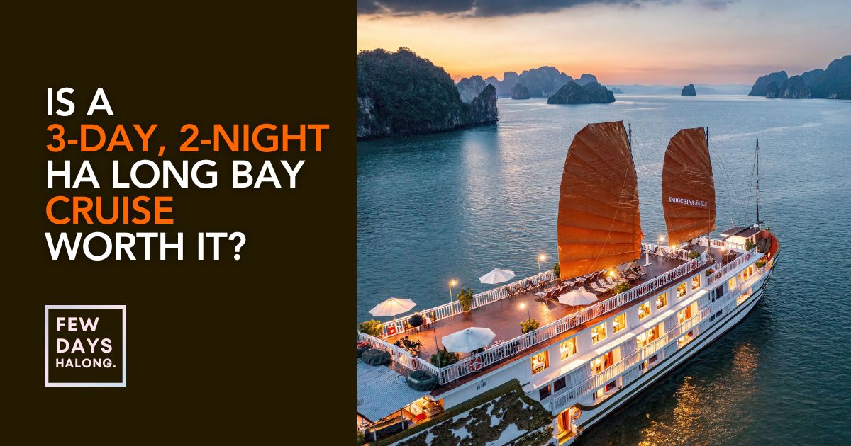 An overnight cruise boat anchored among the limestone karsts of Ha Long Bay at sunrise