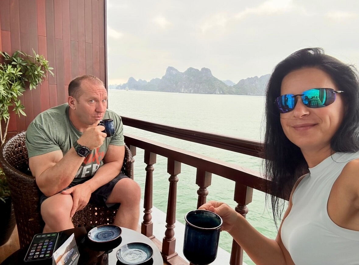Csilla and Fabian enjoying coffee on their cruise balcony over Ha Long Bay Csilla and Fabian enjoying coffee on their cruise balcony over Ha Long Bay