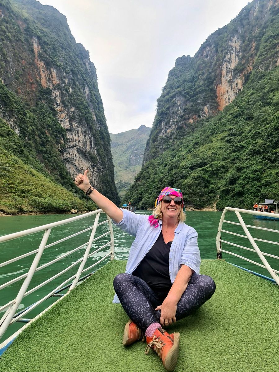 Marg on a boat in the Ha Giang river canyon
